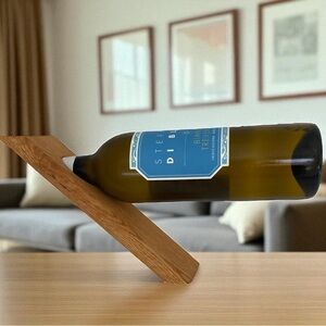 Magic wine bottle holder, optical illusion created by counter balance